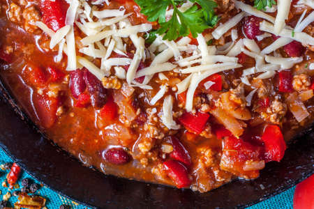 Chilli con carne with cheese and parsley.の写真素材