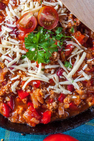 Chilli con carne with cheese and parsley.の写真素材