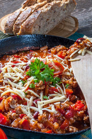 Chilli con carne with cheese and parsley.の写真素材