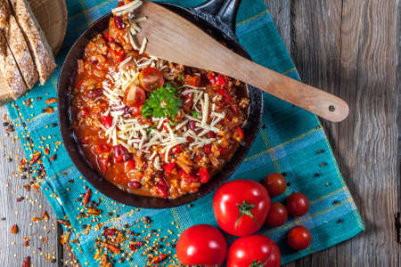 Chilli con carne with cheese and parsley.の写真素材