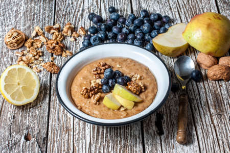 Home porridge with honey nuts and berries.の写真素材