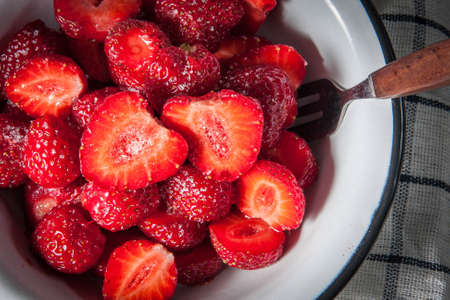 Strawberries with sugar for dessert with fresh milk.の写真素材