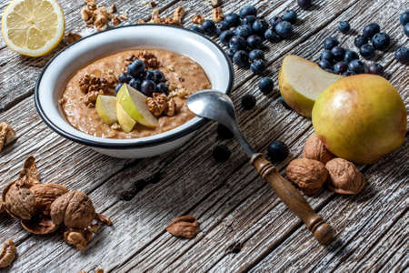 Home porridge with honey, nuts and berries.の写真素材