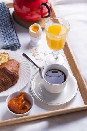 Romantic breakfast in bed on a wooden tray.の写真素材