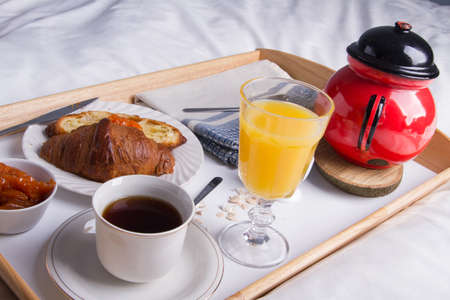 Romantic breakfast in bed on a wooden tray.の写真素材