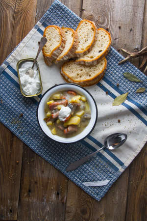 Polish sour soup with sausage and bread.