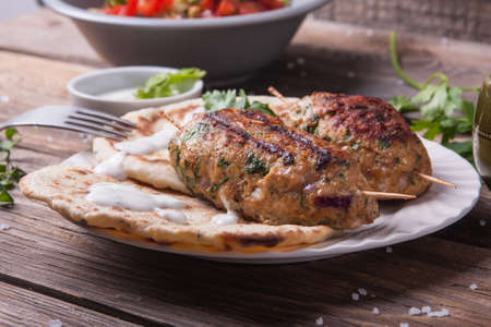 Turkish kofta with flatbread on a plate. Salad and ayran in the backgroundの写真素材