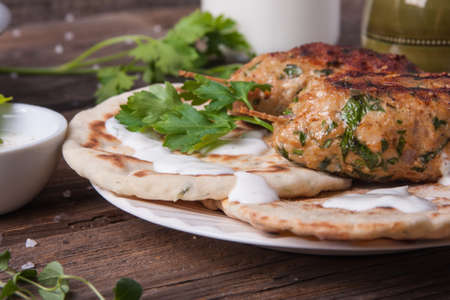 Turkish kofta with flatbread on a plate. Salad and ayran in the backgroundの写真素材
