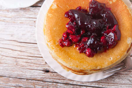 Stack of pancakes on a plate with glass of orange juice and breakfast barsの写真素材