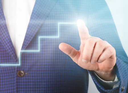 Businessman touching digital screen with the image of growing ladder graph. Business growth conceptの写真素材