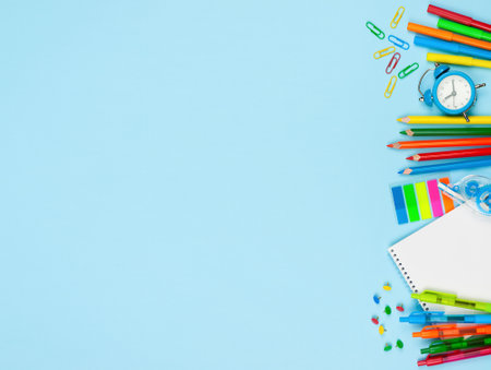 Various school supplies on blue background. Back to school concept. Top view with copy spaceの写真素材