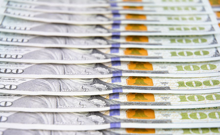 Hundred US dollar bills in a row as a backgroundの写真素材