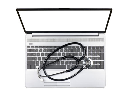 Laptop with blank monitor and stethoscope on keyboard isolated on white background, top viewの写真素材