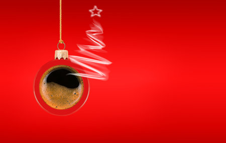 Christmas concept. Hanging red Christmas ornament with coffee and steam in shape of Christmas tree on red backgroundの写真素材