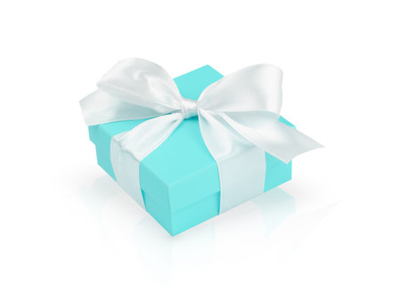 Turquoise gift box with white ribbon isolated on white backgroundの写真素材