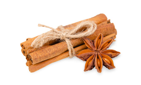 Twine tied cinnamon sticks and star anise isolated on white backgroundの写真素材