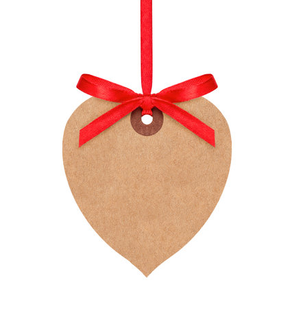 Hanging heart shaped paper tag with red ribbon isolated on white backgroundの写真素材
