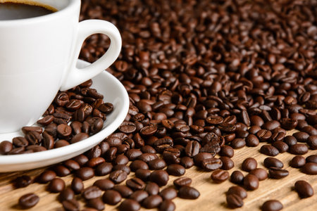 Coffee beans and coffee cup on wooden tableの写真素材