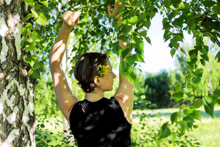 beautiful girl with yellow flowers lies on the grass.の写真素材