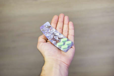 A helping hand always holds out pills to patient
