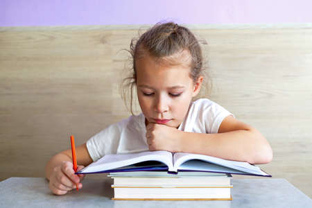Schoolgirl girl reads books after school to know a lot.の写真素材