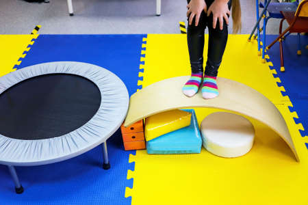 an autistic girl is treated in the form of a game by a psychologist, exercises on the ballancer help brain, balanceの写真素材