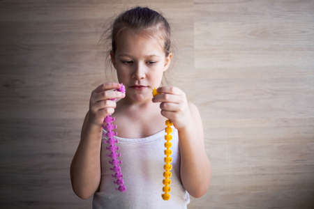 a girl plays with rubber tracks and they fight among themselves.の写真素材