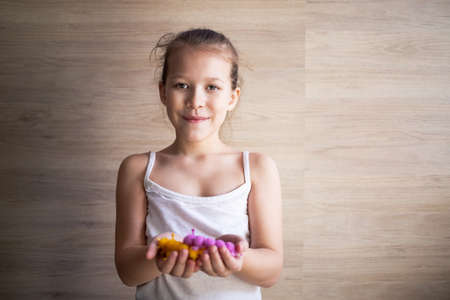 a girl plays with rubber tracks at home and shows them to everyone.の写真素材