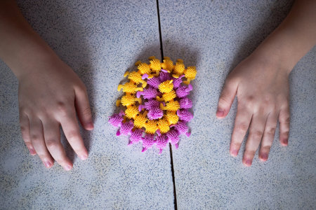toy rubber caterpillars wrapped around themselves like a child's play at the table.の写真素材