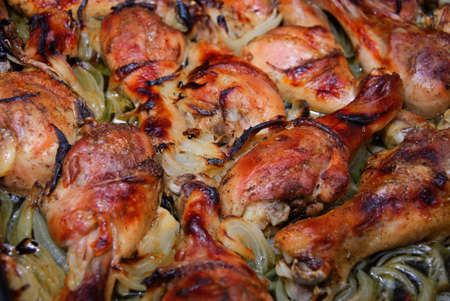 Fresh ripe roasted chicken legs on barbecue pan の写真素材