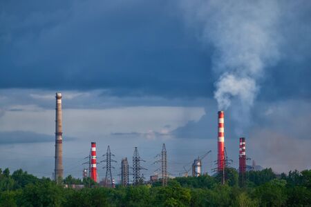 Factory pipe with a smoke and electric mainsの写真素材