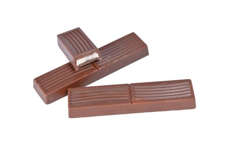 Whole and half small milk chocolate bars isolated on white backgroundの写真素材