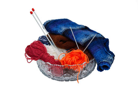 Balls of wool and knitting needles in vase isolated on a white backgroundの写真素材