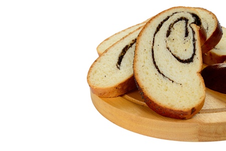 Slice poppy seed roll on cutting board isolated on white backgroundの写真素材