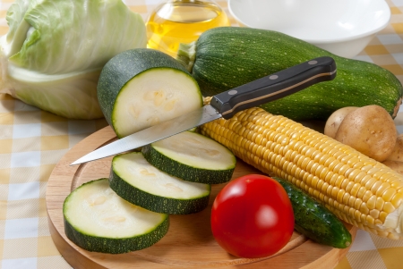 Closeup whole and sliced different vegetables on table, cookingの写真素材