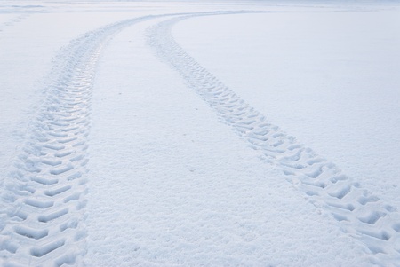 Tire trace on snow leaving to the horizonの写真素材