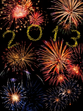 Beautiful colorful 2013 new year fireworks on the black sky backgroundの写真素材