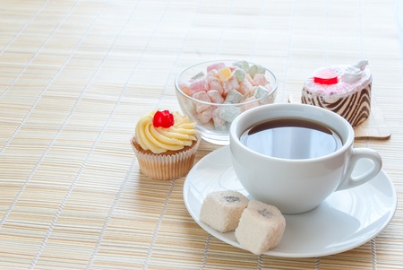 Tea, fresh cherry muffin, colorful delight and various cakeの写真素材