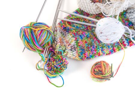 Balls of wool and knitting needles on a white backgroundの写真素材
