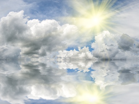 Sun over sea with reflection in water, majestic clouds in the sky