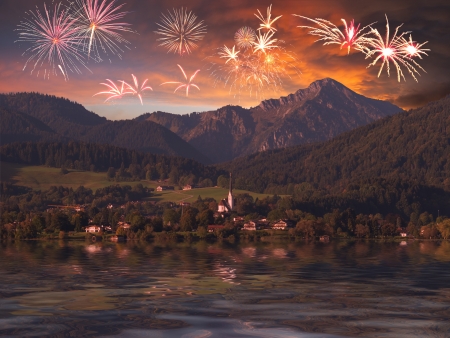 Mountain landscape with holiday fireworks in majestic sky and reflection in water