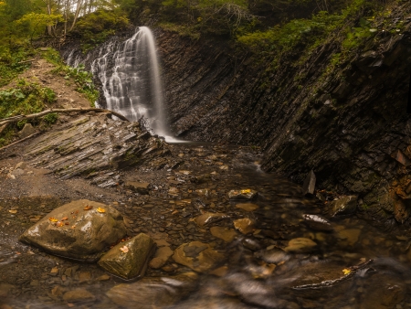 Waterfall in the autumn woods, landscapeの写真素材