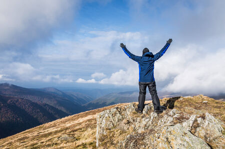 Happy traveler and clouds in mountains