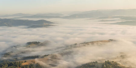 Fog in the valley at dawn, mountaine landscapeの写真素材