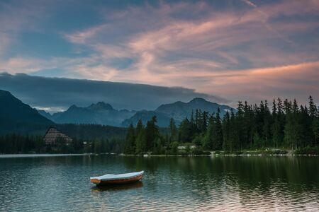 Beautiful landscape with boats on a lake surrounded by high mountains, Å trbskÃ© Plesoの写真素材