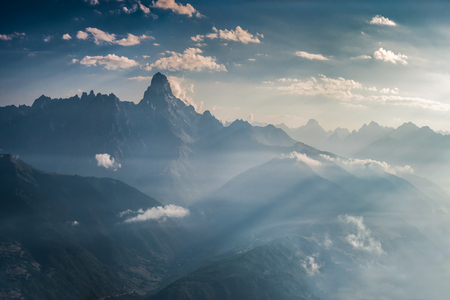 Landscape with majestic mountains in the blue haze and a beautiful sky with cloudsの写真素材