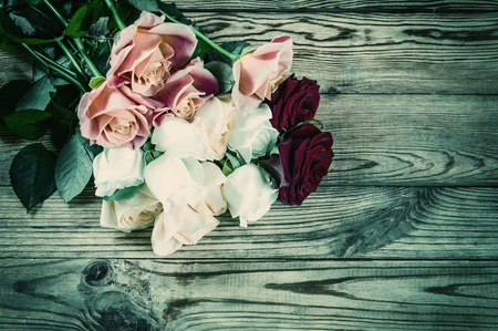 Vintag background with roses flower on rustic tableの写真素材