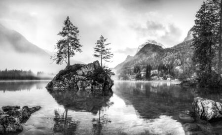 Black and white landscape with foggy lake and mountain, Hintersee, Ramsauの写真素材