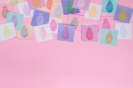 Easter holiday background with eggs painted on paperの写真素材