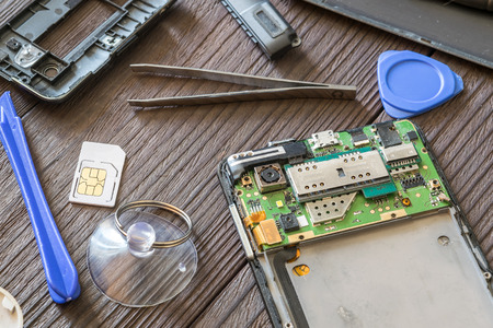 Cell phone repair. Smartphone parts and tools for recovery, selective focus